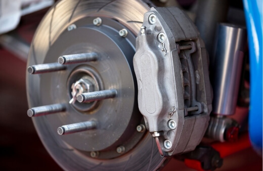 A brake caliper and rotor being replaced by a mobile brake mechanic in Sydney