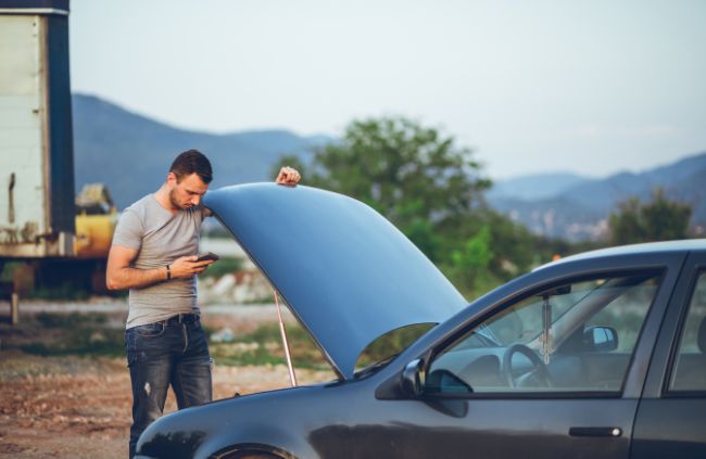 A stranded man waiting for a mobile mechanic starter motor replacement in Sydney