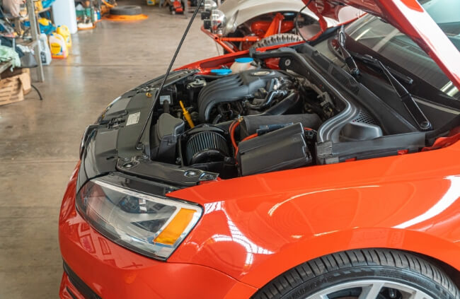 A detailed look under the hood as a technician inspects the vehicle for potential issues or upgrades