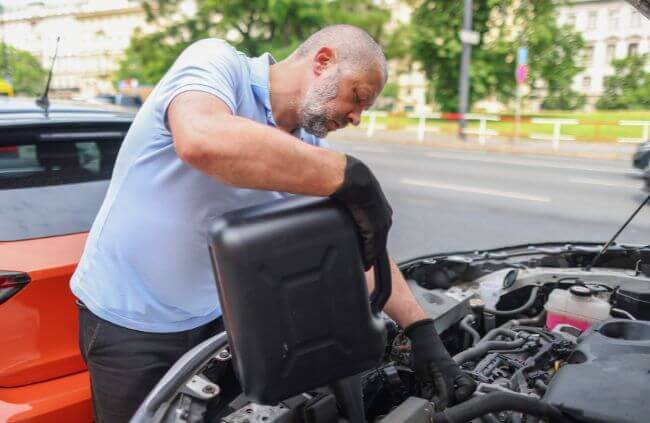 A mobile mechanic in Narellan completing an engine oil refill as part of a roadside service, helping drivers stay on the road with fast and reliable assistance.