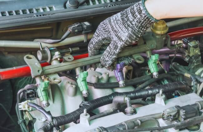Mobile Mechanic Penrith providing expert mobile mechanic services in Werrington inspecting fuel injector connections as part of a detailed car service.
