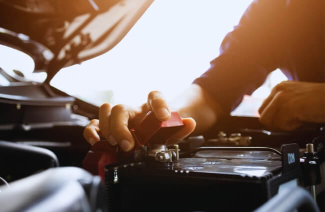 Mobile mechanic in Jordan Springs inspecting battery connections as part of a vehicle repair service